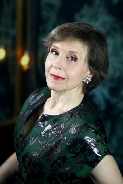 Ann-Christine Larsson close-up in green dress, ambient background texture